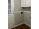 Laundry area with built-in cabinets and hardwood floors at 1044 Tarlton Dr # 0, Shelby, NC 28052