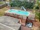 An aerial view of a kidney shaped pool with a slide and firepit at 110 Creekside Dr, Fort Mill, SC 29715