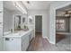 Double vanity bathroom with white cabinets and wood-look floors at 110 Creekside Dr, Fort Mill, SC 29715