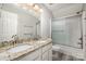 Modern bathroom with double sink vanity, granite countertops, and a shower-tub combination with glass doors at 110 Creekside Dr, Fort Mill, SC 29715