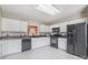 Bright kitchen with white cabinets, tile floors, and black appliances at 110 Creekside Dr, Fort Mill, SC 29715