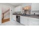 White kitchen cabinets, view of staircase, and dark countertops at 110 Creekside Dr, Fort Mill, SC 29715