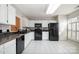 Bright kitchen featuring white cabinets, black appliances, and tile backsplash at 110 Creekside Dr, Fort Mill, SC 29715