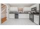 Well-equipped kitchen featuring white cabinets, black appliances, and a view of the dining area at 110 Creekside Dr, Fort Mill, SC 29715