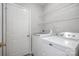 Bright laundry room with washer, dryer, and white wire shelving for optimal storage and organization at 110 Creekside Dr, Fort Mill, SC 29715