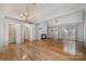 Spacious living room with fireplace, hardwood floors, and a view into the dining and kitchen areas at 110 Creekside Dr, Fort Mill, SC 29715