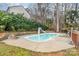 Backyard pool with a slide and firepit surrounded by mature trees at 110 Creekside Dr, Fort Mill, SC 29715