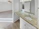 Simple bathroom with granite vanity top and a mirror at 11212 Carmel Chace Dr # 101, Charlotte, NC 28226