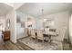 Formal dining room with chandelier, hardwood floors, and seating for six at 12613 Stoneybrook Station Pkwy, Huntersville, NC 28078