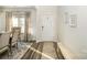 Bright entryway with hardwood floors, bench, and dining room view at 12613 Stoneybrook Station Pkwy, Huntersville, NC 28078