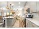 Modern kitchen with gray cabinets, island, and stainless steel appliances at 12613 Stoneybrook Station Pkwy, Huntersville, NC 28078