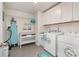 Bright laundry room with washer, dryer, and ample storage at 12613 Stoneybrook Station Pkwy, Huntersville, NC 28078