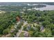 Aerial view of a residential neighborhood with tree-lined streets and lake in the background at 133 Castaway Trl, Mooresville, NC 28117