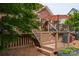 Elevated wooden deck with stairs leading down to the yard and patio area with grill at 133 Castaway Trl, Mooresville, NC 28117