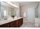 Well-lit bathroom with dual sink vanity, tile flooring, a glass shower and soaking tub at 133 Castaway Trl, Mooresville, NC 28117