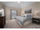 Comfortable main bedroom featuring a vaulted ceiling, carpeted floor and ensuite bath at 133 Castaway Trl, Mooresville, NC 28117