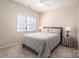 Bedroom with neutral walls, carpet, and a bed between a window and small side table at 133 Castaway Trl, Mooresville, NC 28117