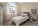 Cozy bedroom featuring a large window, neutral walls and carpet, and a comfortable bed at 133 Castaway Trl, Mooresville, NC 28117