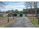 Scenic view of a private boat ramp and dock leading to a serene lake, surrounded by lush greenery and mature trees at 133 Castaway Trl, Mooresville, NC 28117