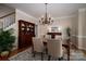 Dining room featuring hardwood floors, a dark wooden hutch and elegant chandelier at 133 Castaway Trl, Mooresville, NC 28117