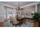 Elegant dining room with hardwood floors, chandelier, and large windows for natural light at 133 Castaway Trl, Mooresville, NC 28117