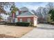 Two-story brick home featuring an attached garage, manicured landscaping, and a long driveway at 133 Castaway Trl, Mooresville, NC 28117