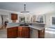 Spacious kitchen features a breakfast bar with granite countertops and wood cabinets at 133 Castaway Trl, Mooresville, NC 28117