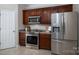 Well-lit kitchen features stainless steel appliances, dark cabinetry and granite countertops at 133 Castaway Trl, Mooresville, NC 28117