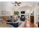 Cozy living room with high ceilings, fireplace, large windows, and hardwood floors at 133 Castaway Trl, Mooresville, NC 28117