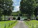 A well-manicured lawn leads to a serene lake with several boats docked in a secluded waterfront paradise at 133 Castaway Trl, Mooresville, NC 28117