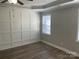 Large bedroom with wood-look floors and wainscoting at 1336 Stonecrest Blvd, Fort Mill, SC 29708