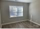 Well-lit bedroom featuring wood-look floors at 1336 Stonecrest Blvd, Fort Mill, SC 29708