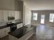 Modern kitchen with island, stainless steel appliances, and white cabinets at 1336 Stonecrest Blvd, Fort Mill, SC 29708