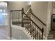 Elegant staircase with dark wood railings at 1336 Stonecrest Blvd, Fort Mill, SC 29708