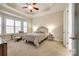 Main bedroom with carpeted floors, tray ceiling, and ample natural light at 1380 Secret Path Dr, Fort Mill, SC 29708