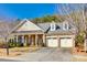 Brick ranch home with three-car garage and front porch at 1380 Secret Path Dr, Fort Mill, SC 29708