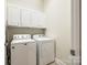 Bright laundry room with washer, dryer, and ample cabinet space at 1380 Secret Path Dr, Fort Mill, SC 29708