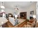 Bright living room with hardwood floors, fireplace, and view into kitchen at 1380 Secret Path Dr, Fort Mill, SC 29708