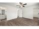 Bright bedroom with wood-look floors, ceiling fan, and en-suite bathroom at 1506 Collinston Dr, Gastonia, NC 28052