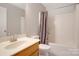 Small bathroom with single sink vanity and tub shower at 2111 Bennett Woods Ct, Charlotte, NC 28216