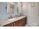 Bathroom with granite countertops, double sinks, and a separate shower at 2111 Bennett Woods Ct, Charlotte, NC 28216