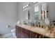 Bathroom with granite countertops, double sinks, and large mirrors at 2111 Bennett Woods Ct, Charlotte, NC 28216