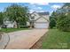 House exterior showcasing a driveway and landscaping at 2111 Bennett Woods Ct, Charlotte, NC 28216