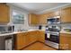 Kitchen with stainless steel appliances and wood cabinets at 2111 Bennett Woods Ct, Charlotte, NC 28216