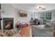 Living room with fireplace, hardwood floors, and comfortable seating at 2111 Bennett Woods Ct, Charlotte, NC 28216