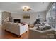 Living room featuring a fireplace, large TV, and work area at 2111 Bennett Woods Ct, Charlotte, NC 28216