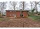 Brick home with a patio and a sloped backyard at 218 Kingsway Cir, Charlotte, NC 28214