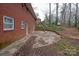 Brick home with a small patio and wooded backyard at 218 Kingsway Cir, Charlotte, NC 28214