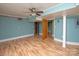 Spacious basement with light teal walls and wood flooring at 218 Kingsway Cir, Charlotte, NC 28214