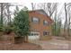 Brick garage with a white door and black shutters at 218 Kingsway Cir, Charlotte, NC 28214